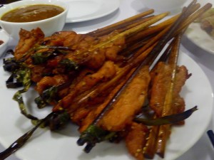 Grilled/BBQ marinaded pork on bamboo sticks.